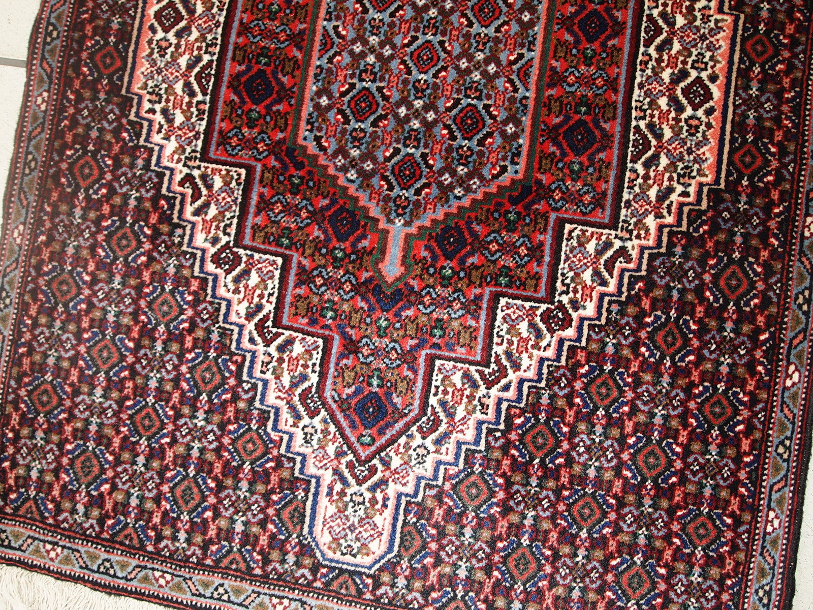 Handmade vintage Nain rug in original good condition. The rug is from the end of 20th century made in wool.