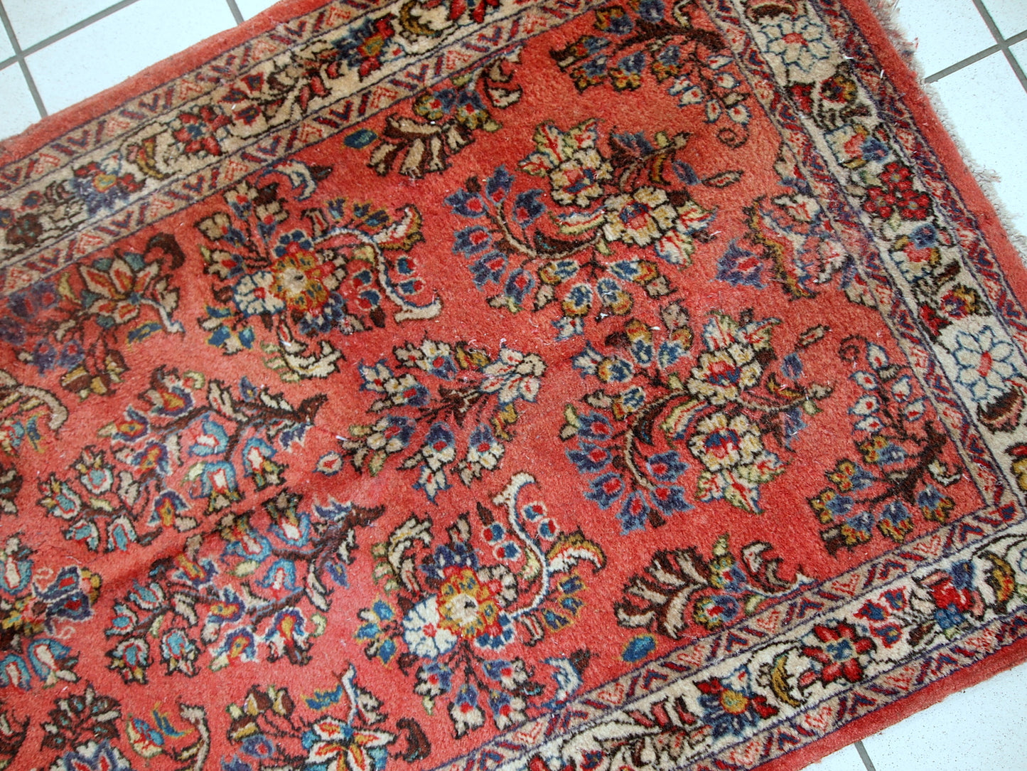 Handmade vintage Sarouk runner in original good condition. The rug is from the end of 20th century made in red wool.