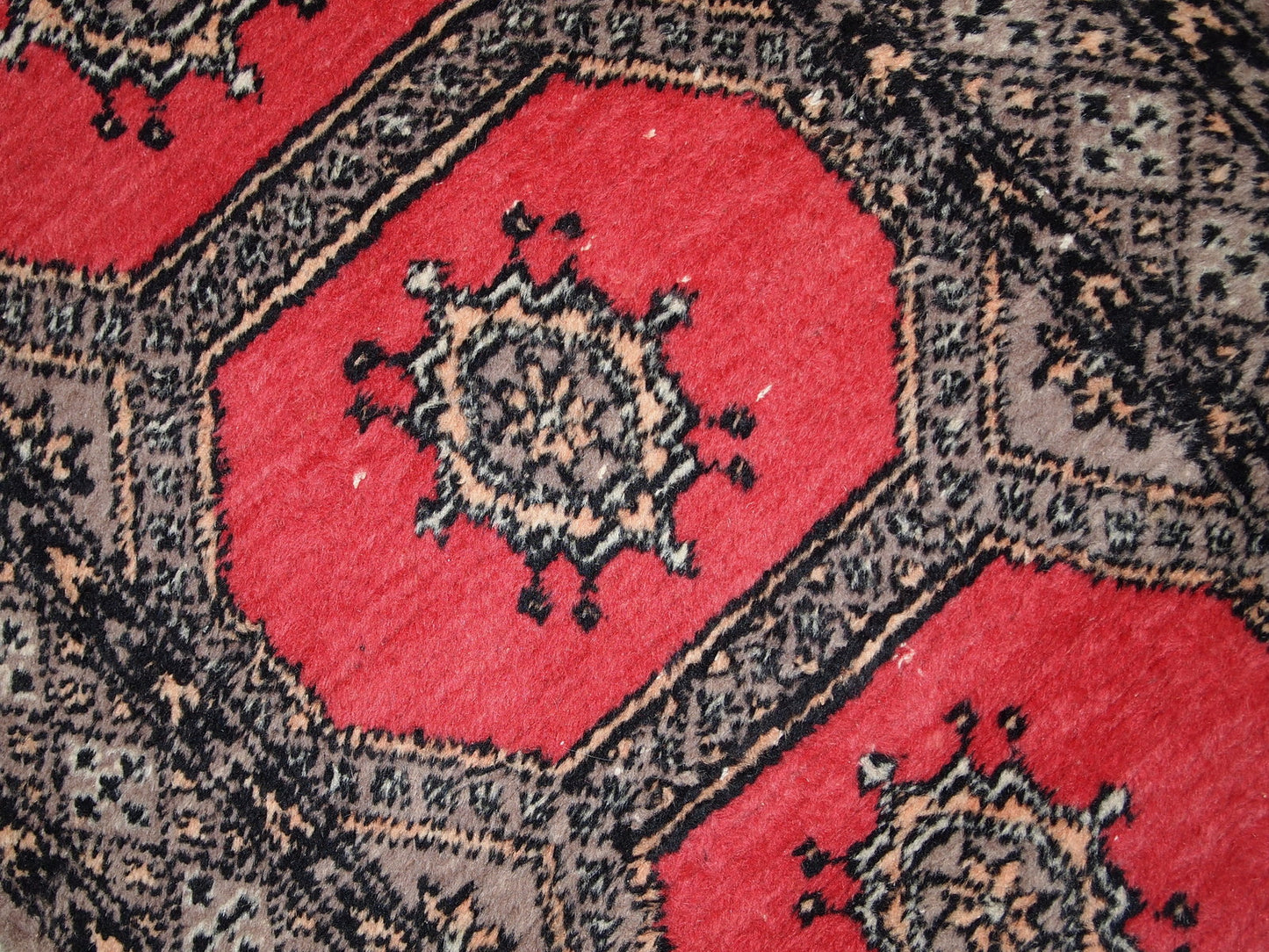 Vintage Uzbek Bukhara rug in original good condition from the middle of 20th century. The rug has been made in red wool. 