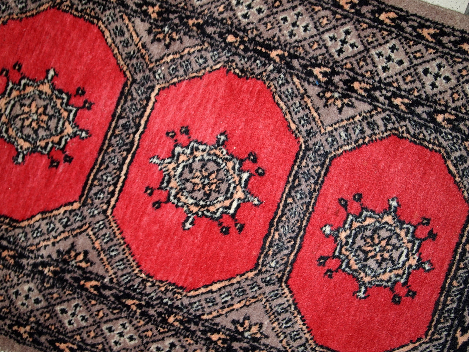 Vintage Uzbek Bukhara rug in original good condition from the middle of 20th century. The rug has been made in red wool. 
