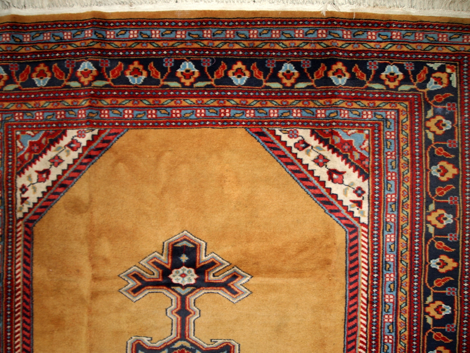 Vintage Uzbek Bukhara rug in original good condition from the middle of 20th century. The rug has been made in yellow wool. 