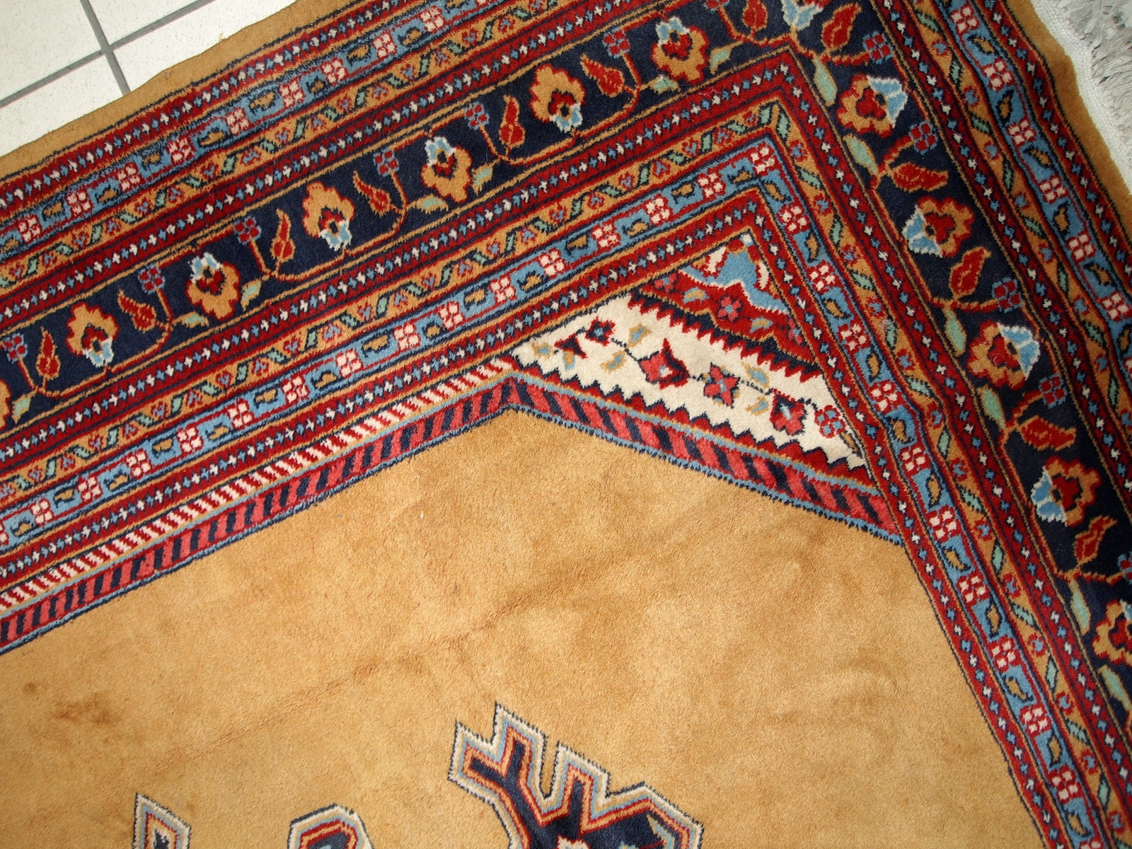 Vintage Uzbek Bukhara rug in original good condition from the middle of 20th century. The rug has been made in yellow wool. 