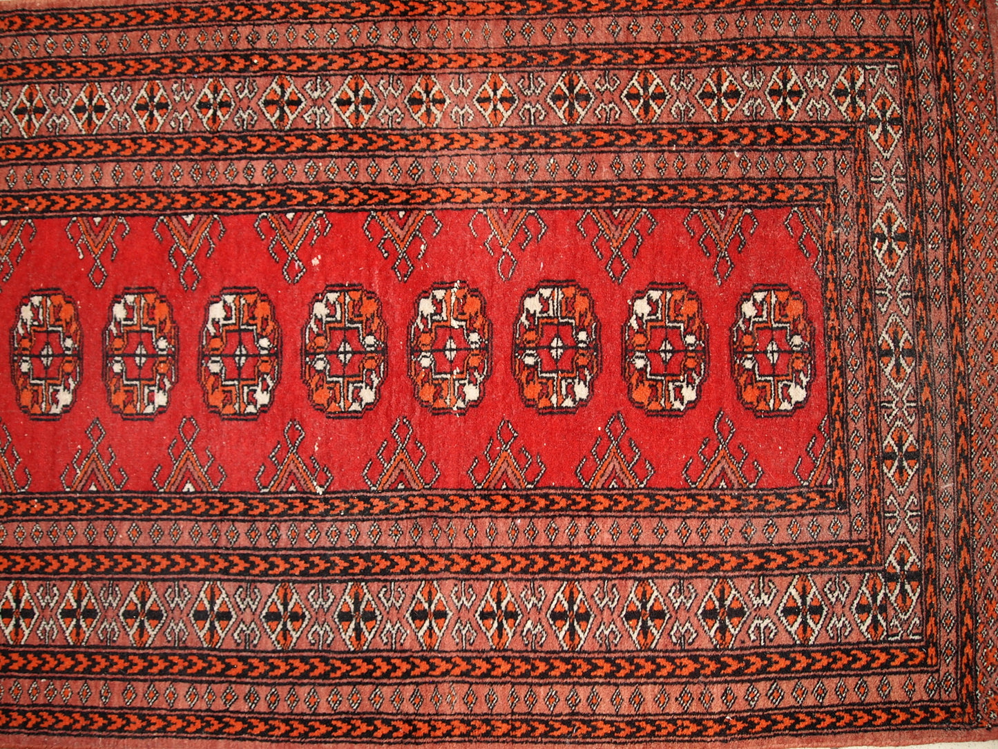 Vintage handmade Pakistani Lahore rug in original good condition. The rug has been made in wool in the middle of 20th century.