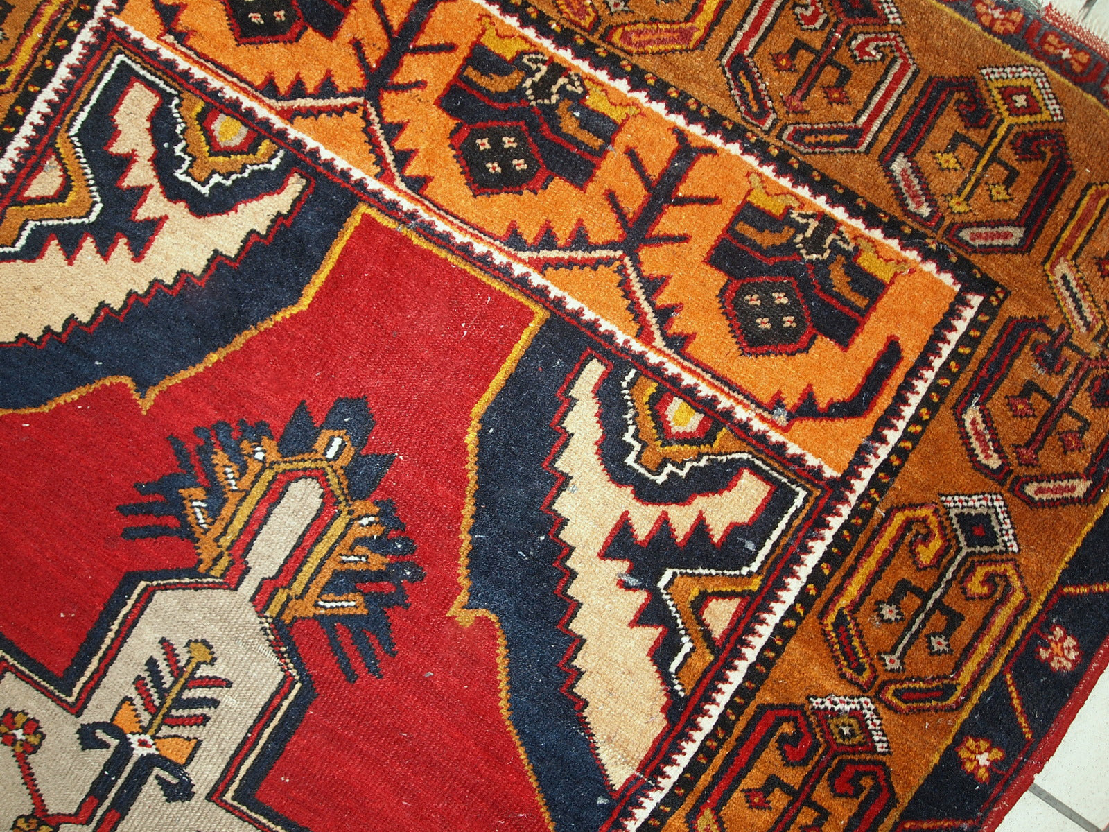 Antique Turkish Anatolian rug in distressed condition. The rug made in traditional Anatolian design in red, yellow, navy blue and grey shades. ​The rug made in the beginning of 20th century.
