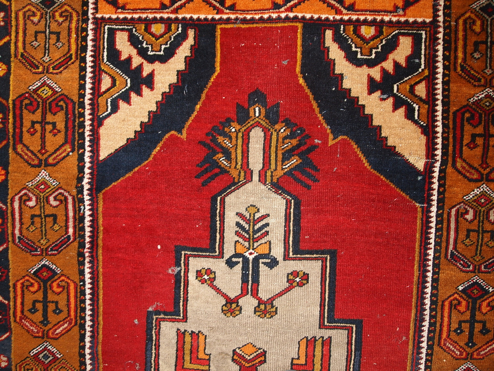 Antique Turkish Anatolian rug in distressed condition. The rug made in traditional Anatolian design in red, yellow, navy blue and grey shades. ​The rug made in the beginning of 20th century.