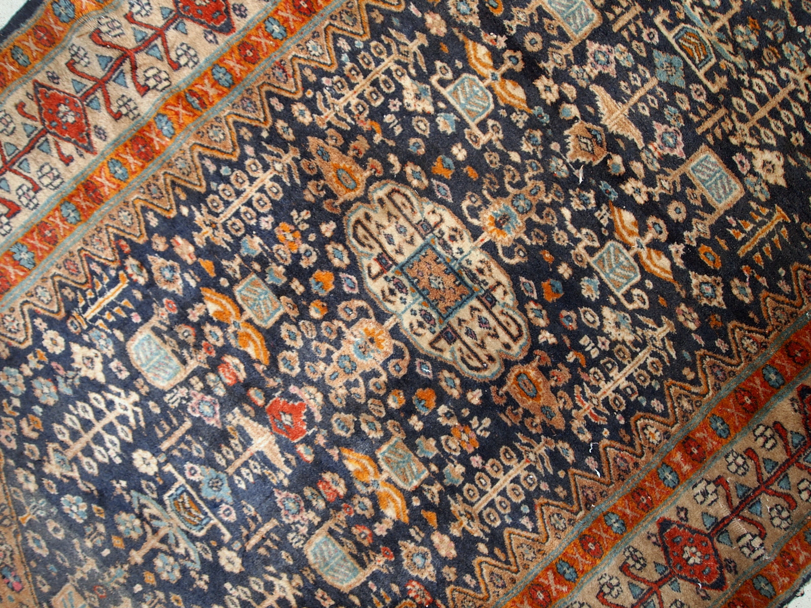 Handmade antique Baluch rug from Central Asia in original condition, it has some age wear. The rug is from the beginning of 20th century.