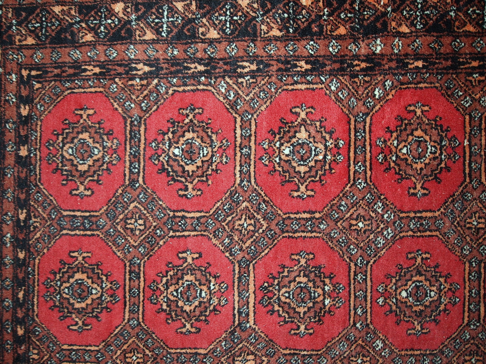 Handmade vintage Uzbek Bukhara rug in original good condition. The rug made in soft wool in the middle of 20th century. 