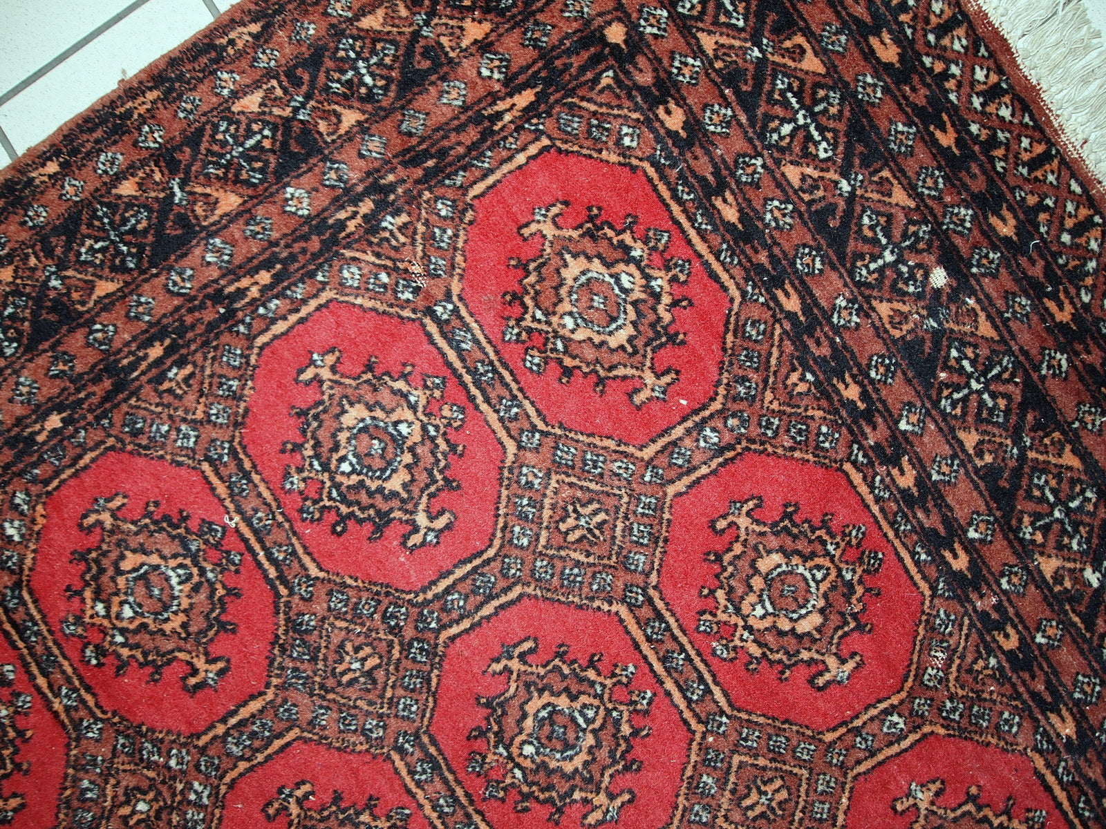 Handmade vintage Uzbek Bukhara rug in original good condition. The rug made in soft wool in the middle of 20th century. 
