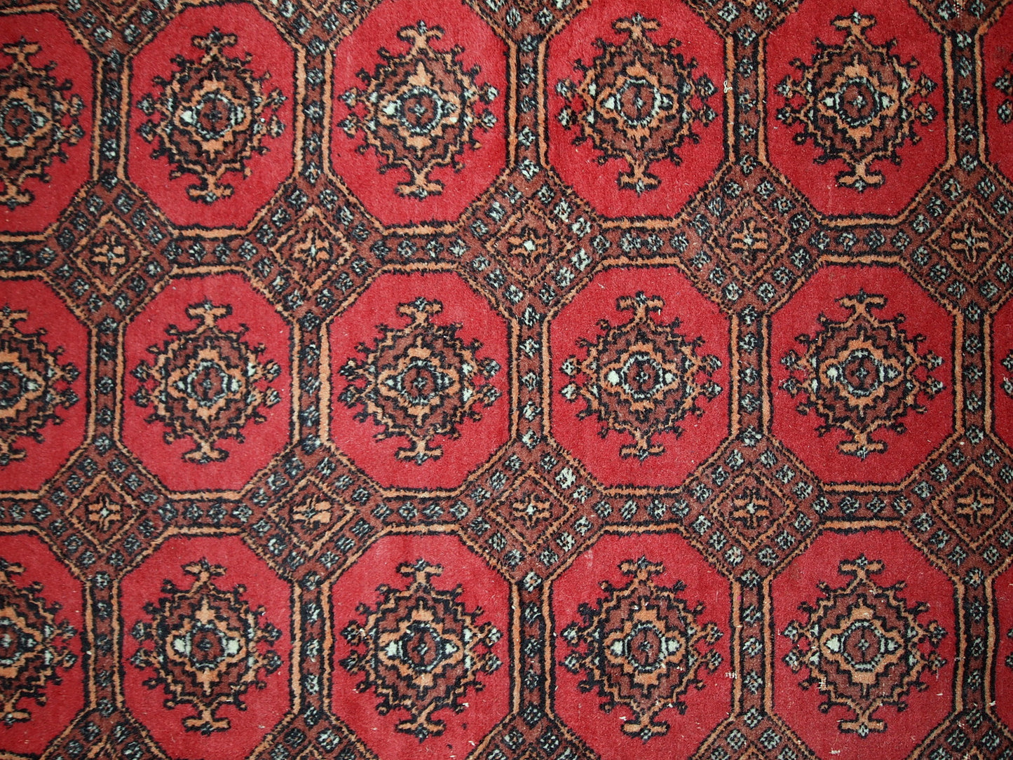 Handmade vintage Uzbek Bukhara rug in original good condition. The rug made in soft wool in the middle of 20th century. 