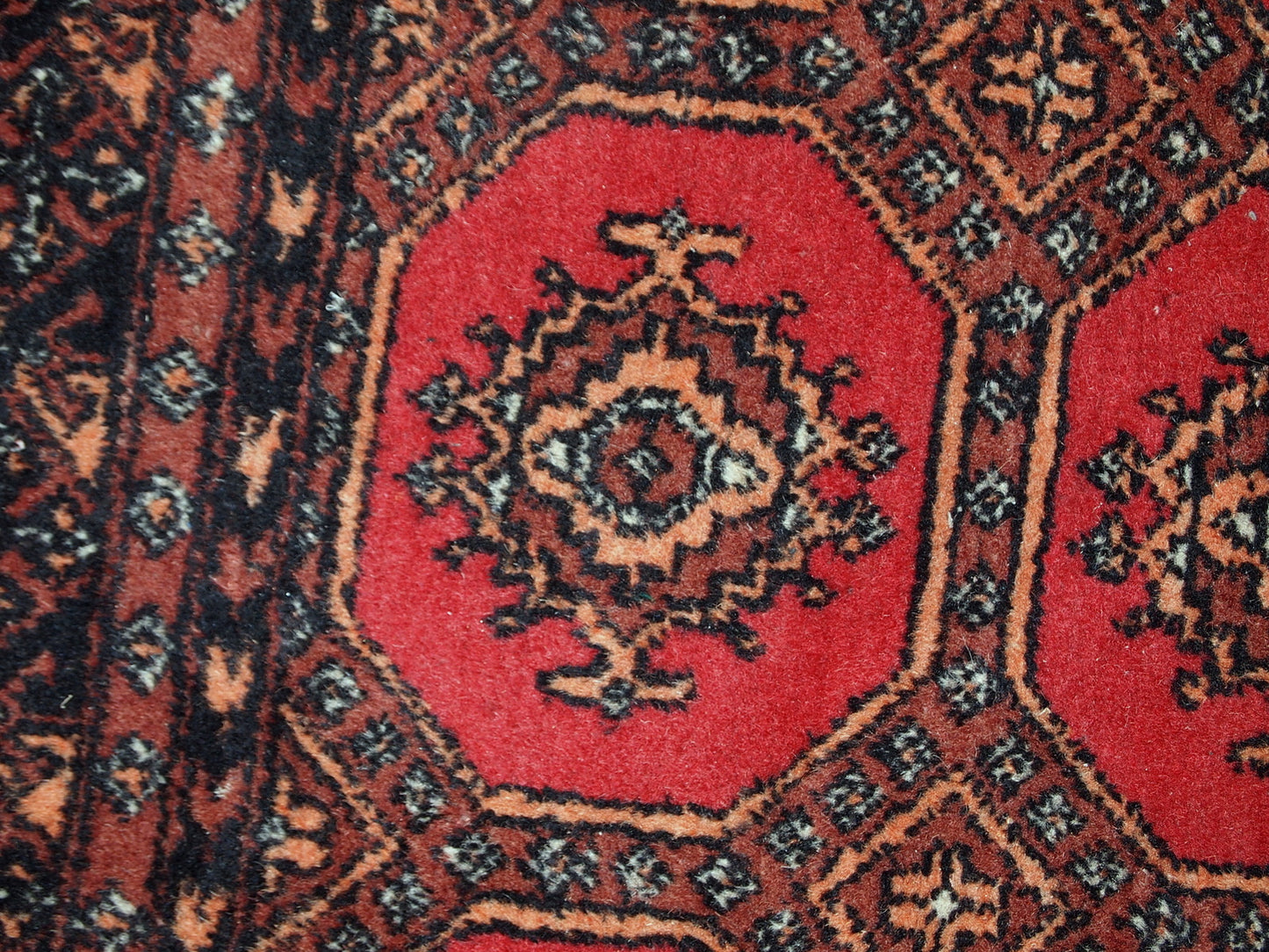Handmade vintage Uzbek Bukhara rug in original good condition. The rug made in soft wool in the middle of 20th century. 