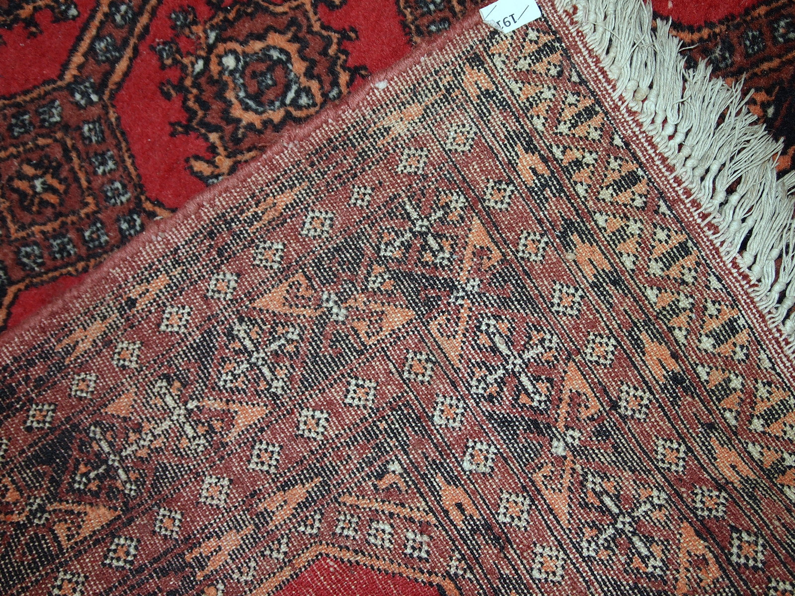 Handmade vintage Uzbek Bukhara rug in original good condition. The rug made in soft wool in the middle of 20th century. 