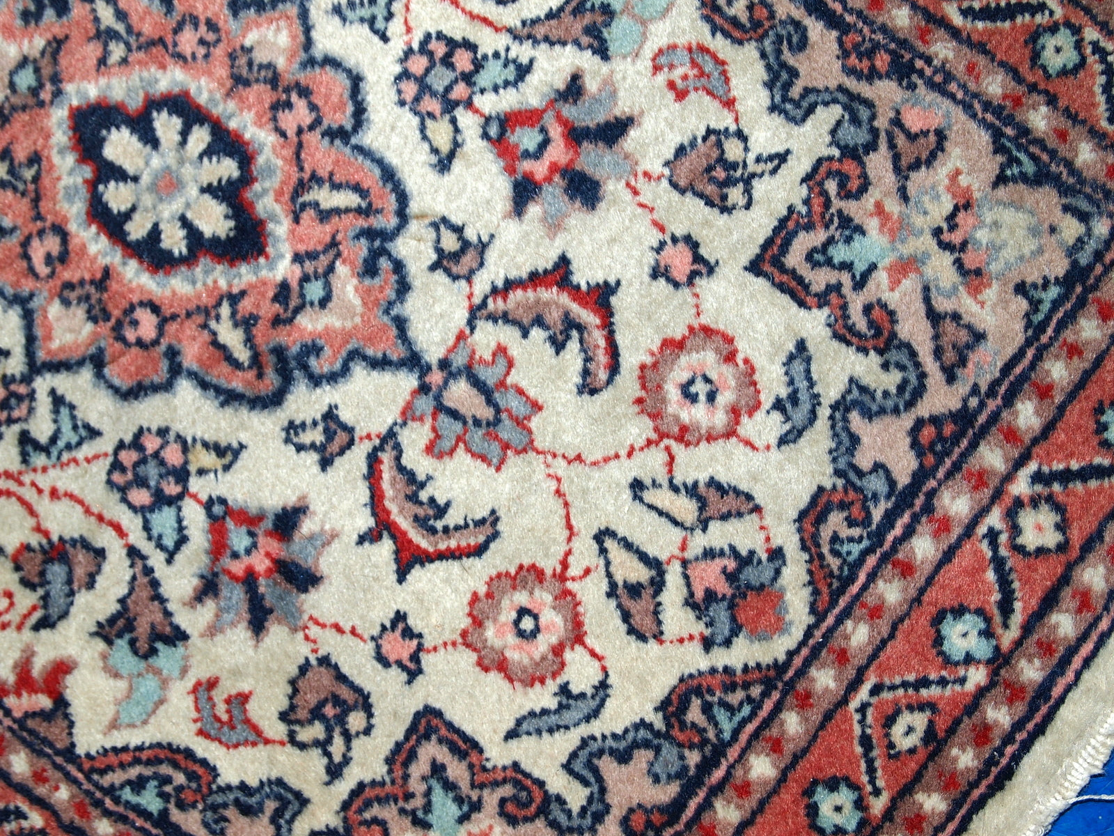 Vintage handmade Indian rug from the end of 20th century. The rug is in original good condition in a beige shade and floral design.