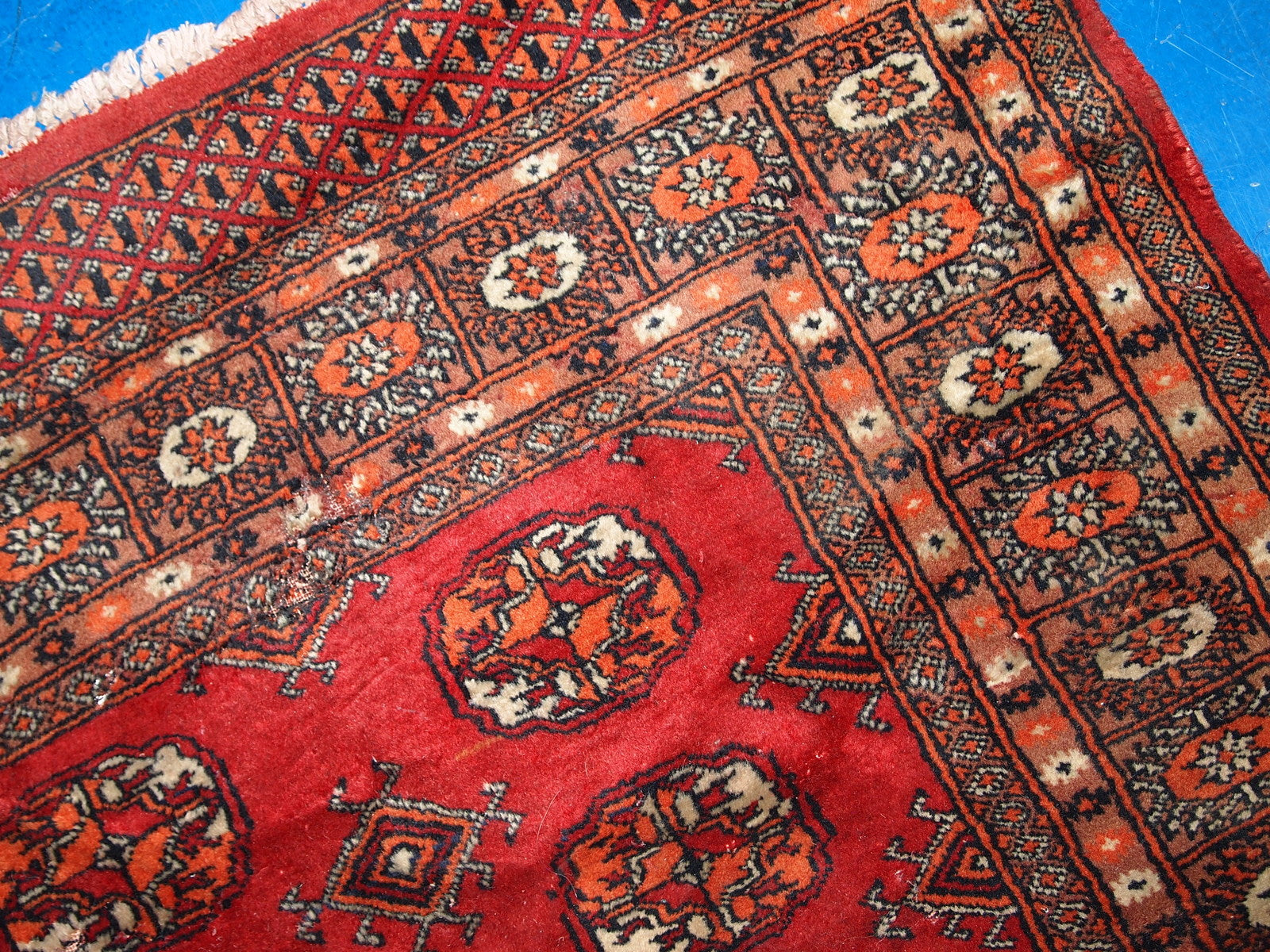 Vintage handmade Central Asian rug from Uzbekistan. The rug is in original good condition from the end of 20th century, it has minimal signs of age. It has been made from red wool and in classic Bukhara design.