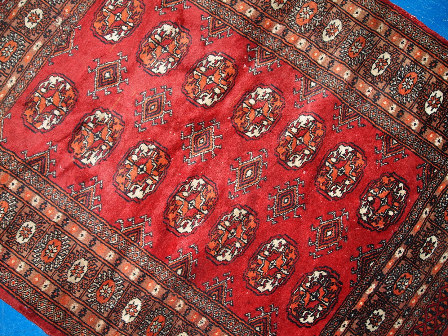 Vintage handmade Central Asian rug from Uzbekistan. The rug is in original good condition from the end of 20th century, it has minimal signs of age. It has been made from red wool and in classic Bukhara design.