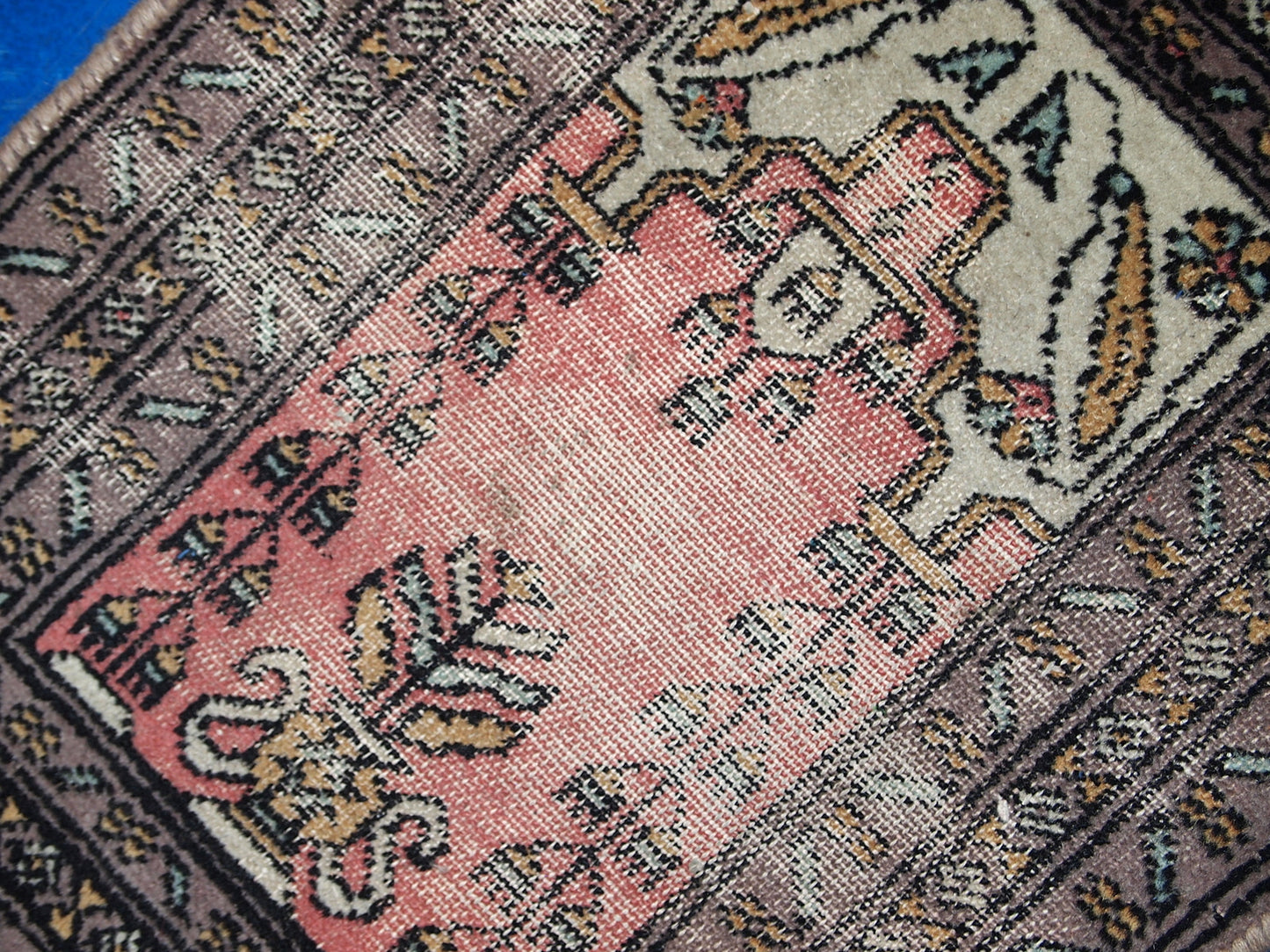 Vintage handmade Uzbek Bukhara praying mat in distressed condition. The rug is from the end of 20th century.