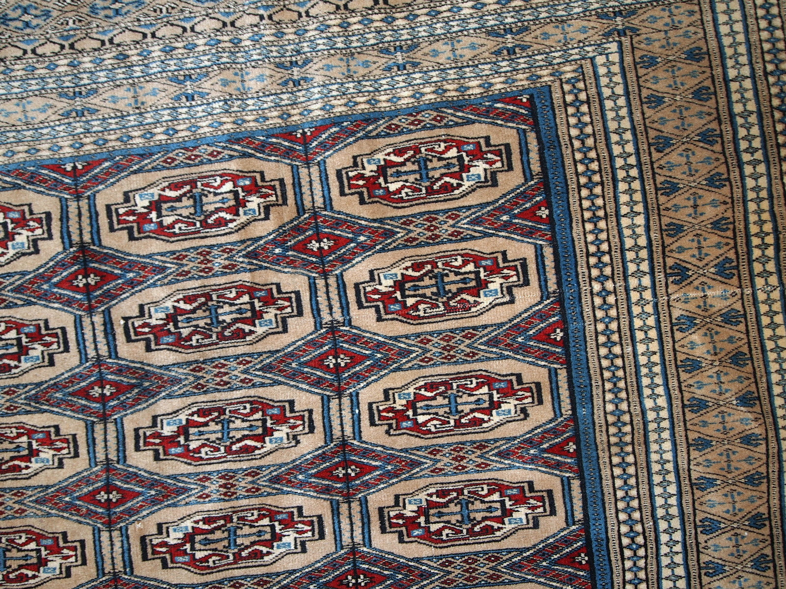 Handmade vintage Uzbek Bukhara rug in original good condition. The rug is from the middle of 20th century in brown and burgundy shades.