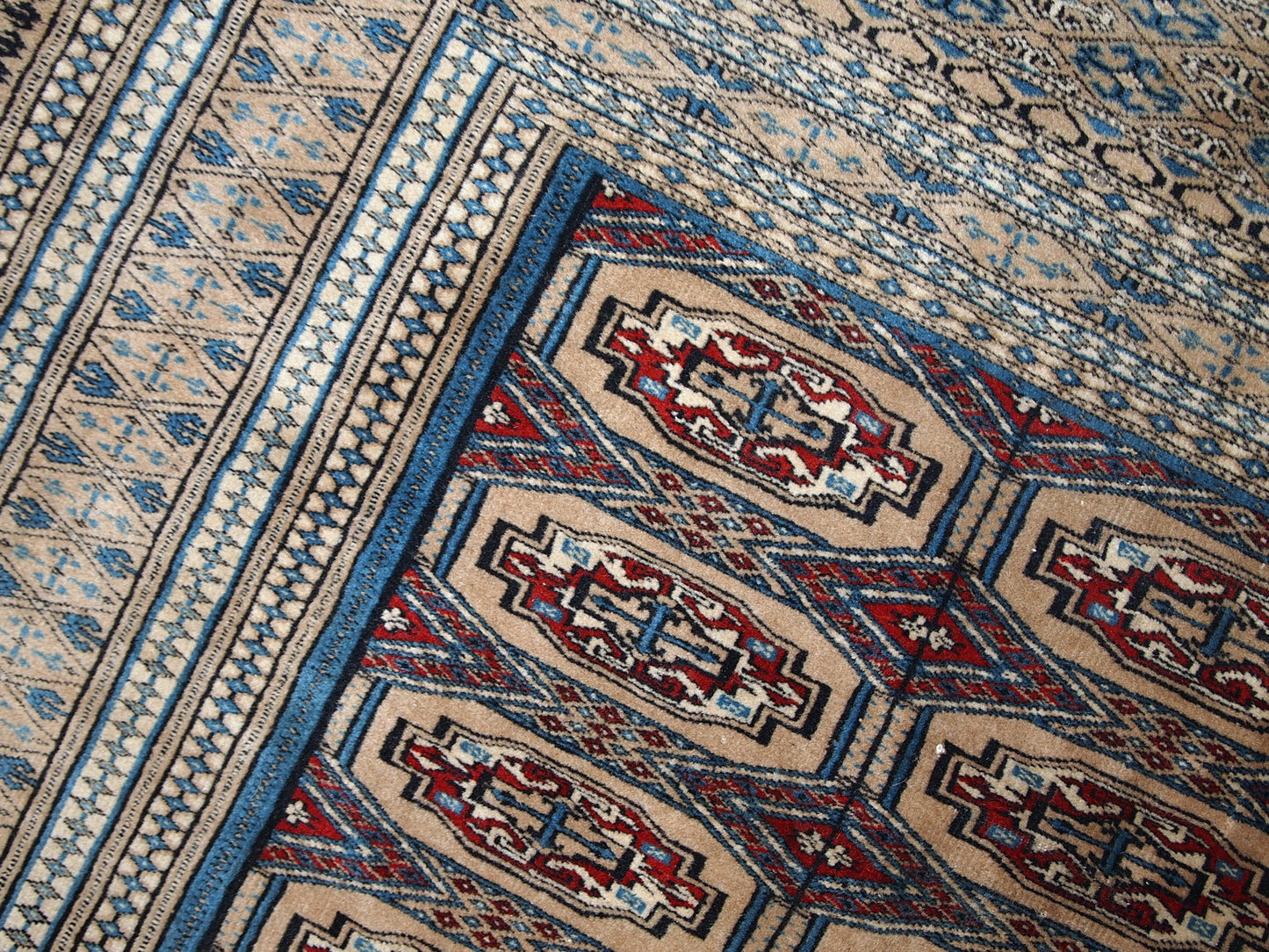 Handmade vintage Uzbek Bukhara rug in original good condition. The rug is from the middle of 20th century in brown and burgundy shades.