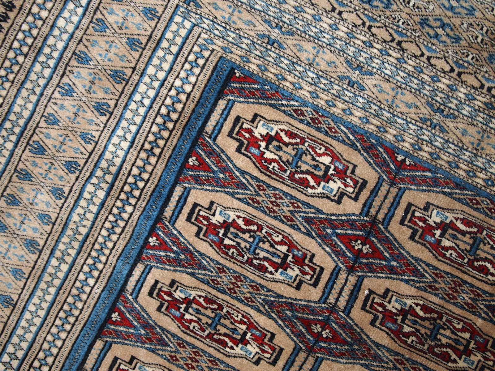 Handmade vintage Uzbek Bukhara rug in original good condition. The rug is from the middle of 20th century in brown and burgundy shades.