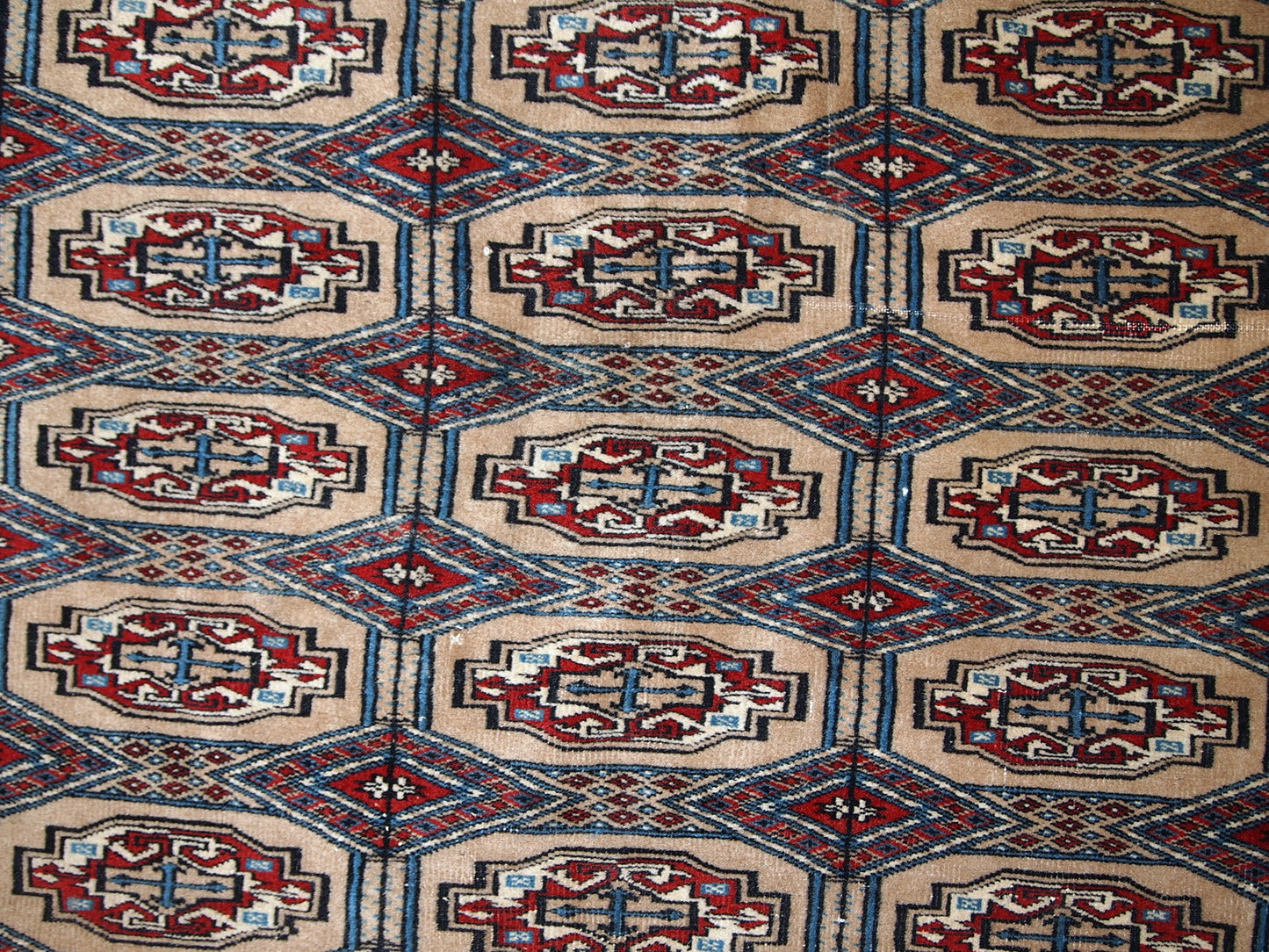 Handmade vintage Uzbek Bukhara rug in original good condition. The rug is from the middle of 20th century in brown and burgundy shades.
