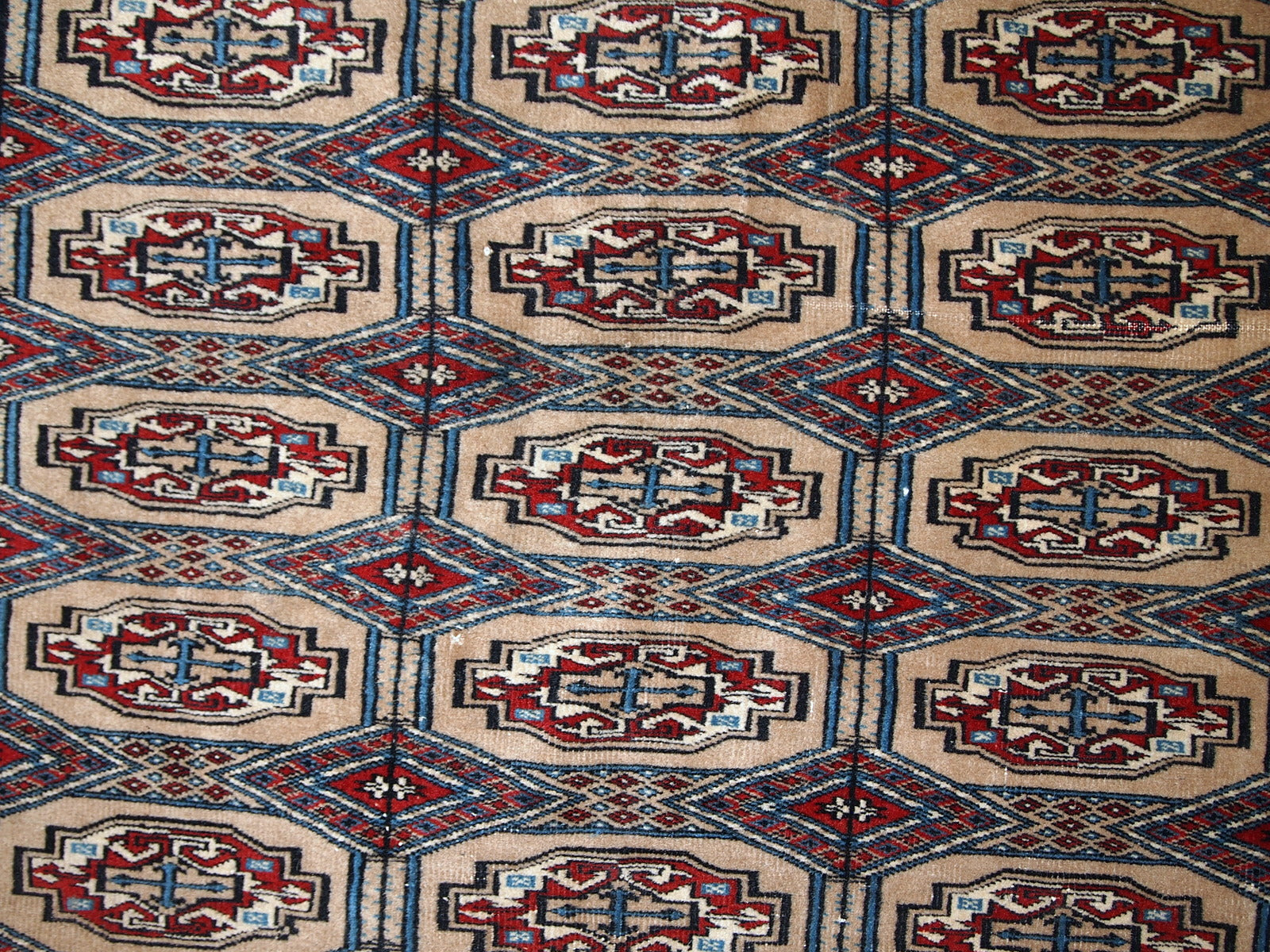 Handmade vintage Uzbek Bukhara rug in original good condition. The rug is from the middle of 20th century in brown and burgundy shades.