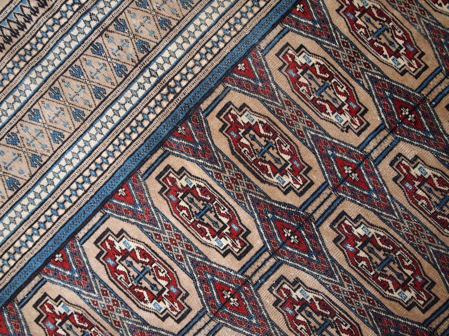 Handmade vintage Uzbek Bukhara rug in original good condition. The rug is from the middle of 20th century in brown and burgundy shades.
