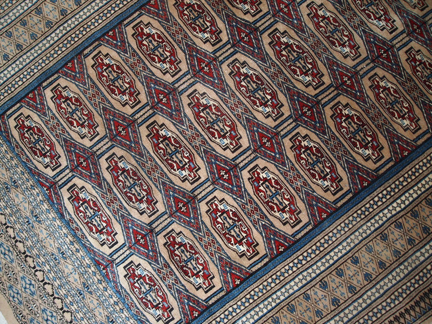 Handmade vintage Uzbek Bukhara rug in original good condition. The rug is from the middle of 20th century in brown and burgundy shades.
