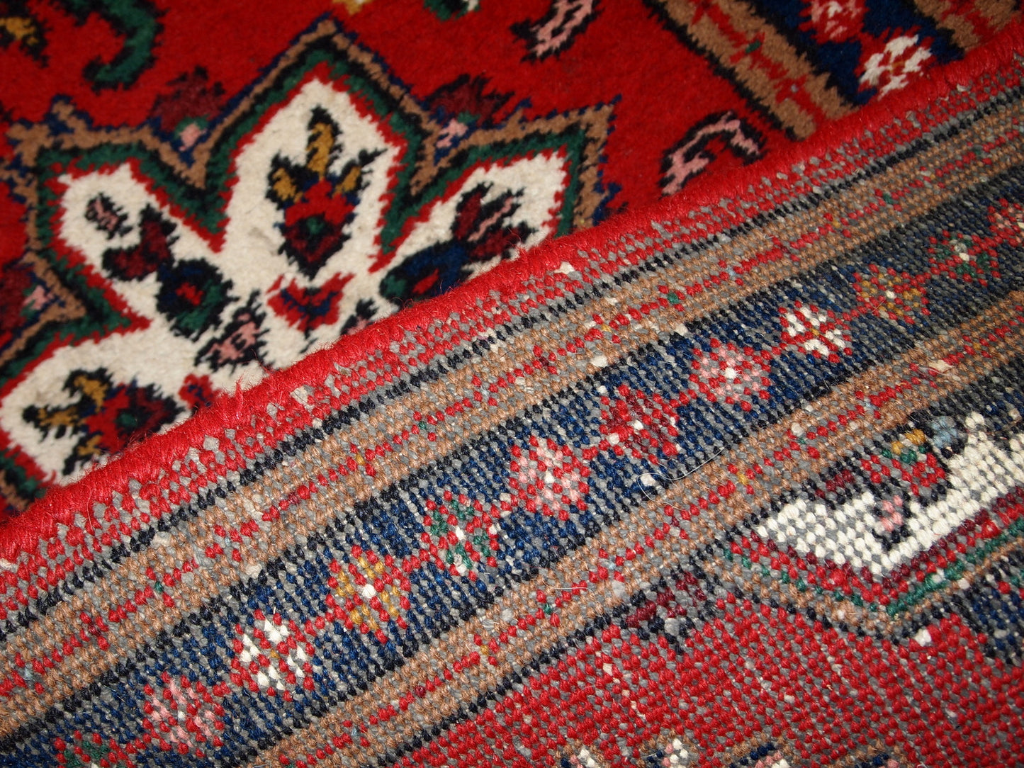 Handmade vintage Middle Eastern rug in traditional floral design. The rug is from the end of 20th century in original good condition.