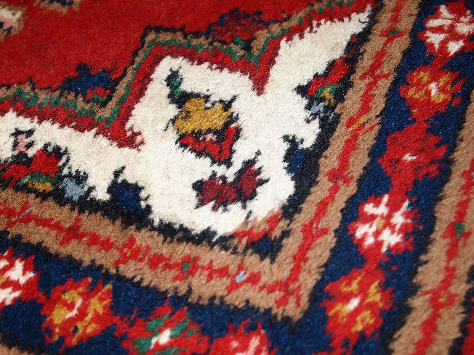 Handmade vintage Middle Eastern rug in traditional floral design. The rug is from the end of 20th century in original good condition.