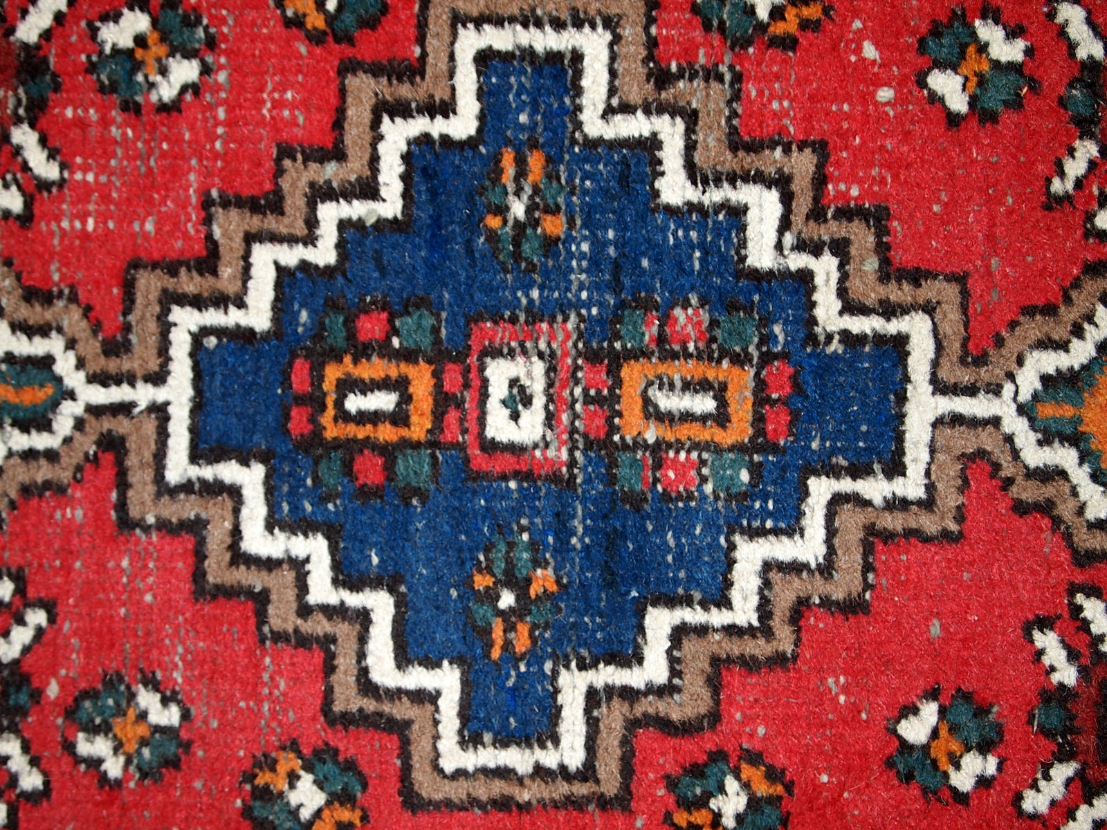 Handmade vintage Middle Eastern rug in traditional design. The rug is from the end of 20th century in original condition, it has some signs of age.