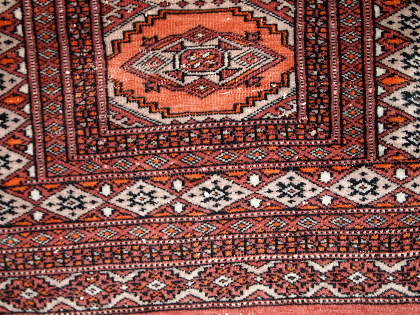 Handmade vintage Uzbek Bukhara distressed rug 1960s