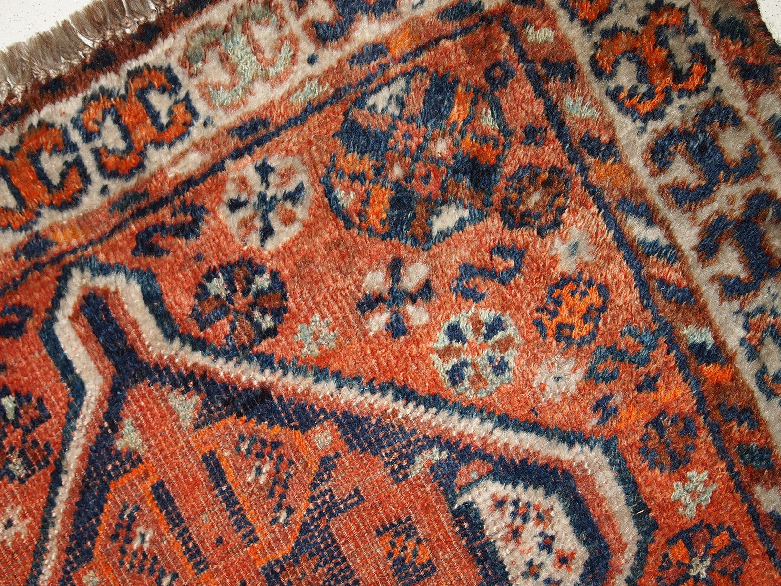 Handmade antique Middle Eastern rug in traditional design. The rug is from the beginning of 20th century in distressed condition. 