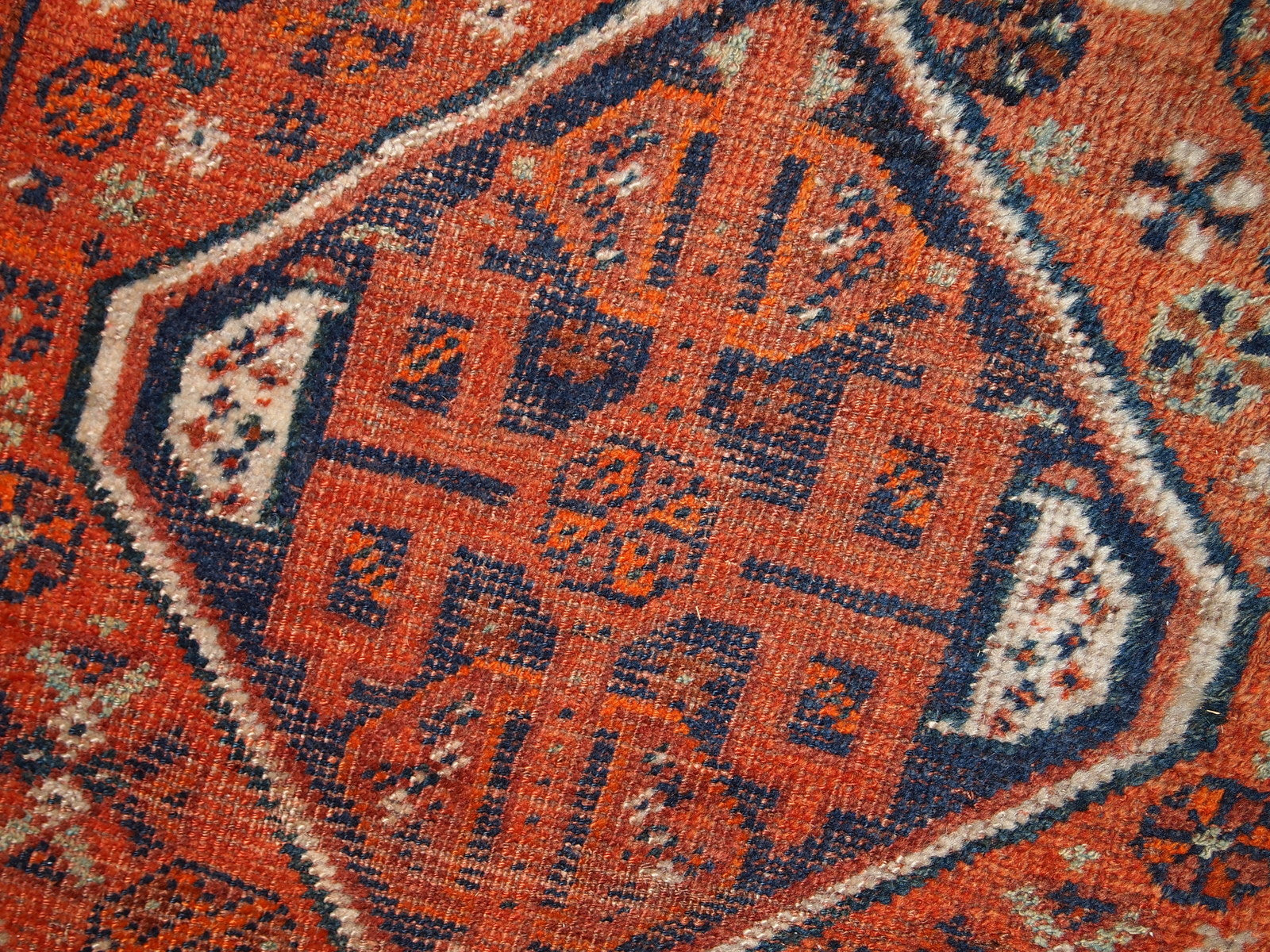 Handmade antique Middle Eastern rug in traditional design. The rug is from the beginning of 20th century in distressed condition. 