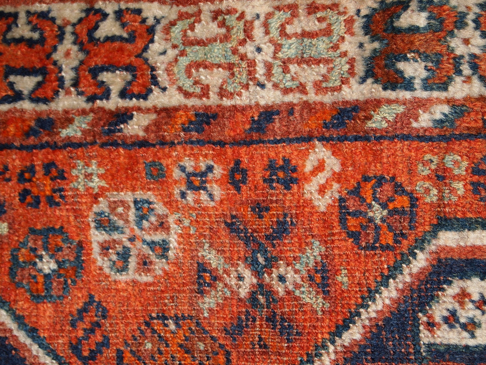Handmade antique Middle Eastern rug in traditional design. The rug is from the beginning of 20th century in distressed condition. 