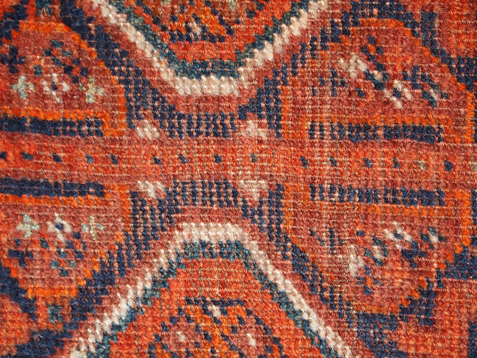 Handmade antique Middle Eastern rug in traditional design. The rug is from the beginning of 20th century in distressed condition. 