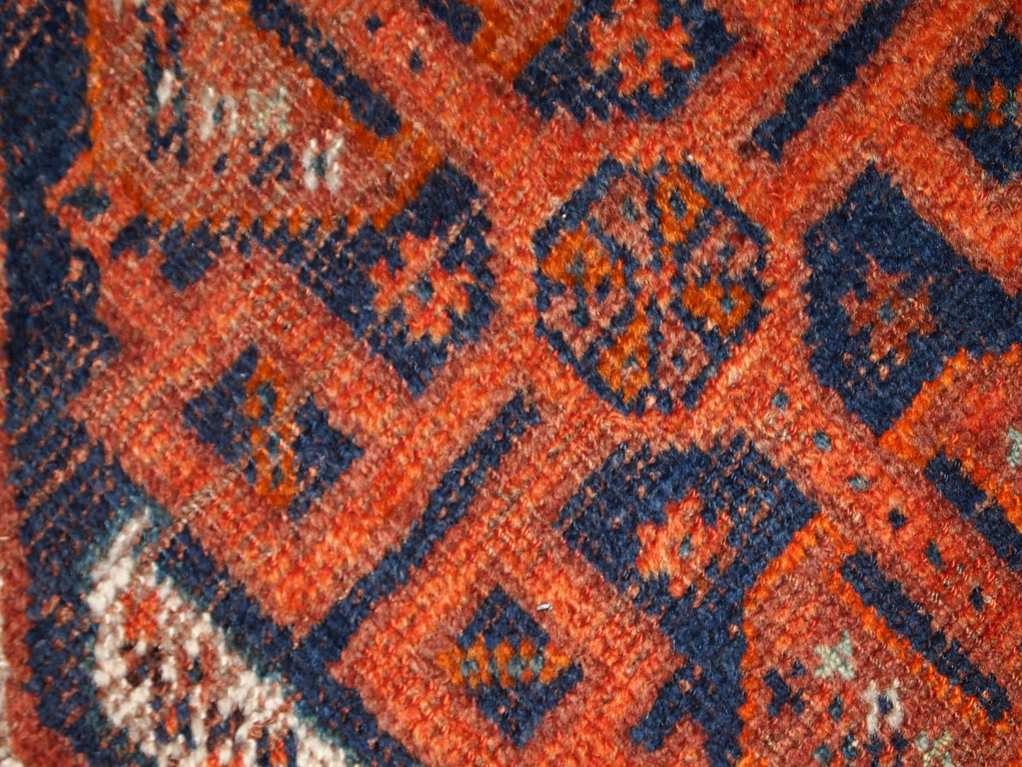 Handmade antique Middle Eastern rug in traditional design. The rug is from the beginning of 20th century in distressed condition. 