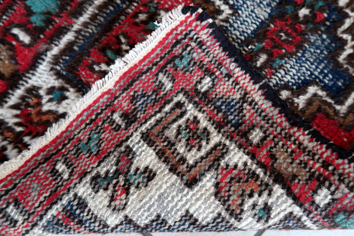 Handmade vintage Persian Hamadan rug in distressed condition. The rug has been made in wool in the end of 20th century.