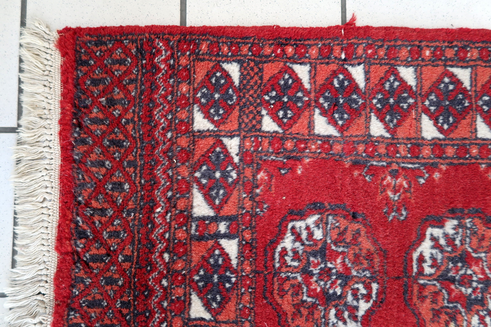 Handmade vintage Afghan Ersari rug in original good condition. The rug has been made in wool in the end of 20th century.