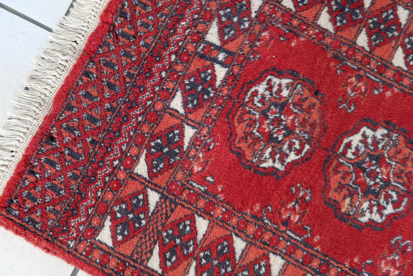 Handmade vintage Afghan Ersari rug in original good condition. The rug has been made in wool in the end of 20th century.
