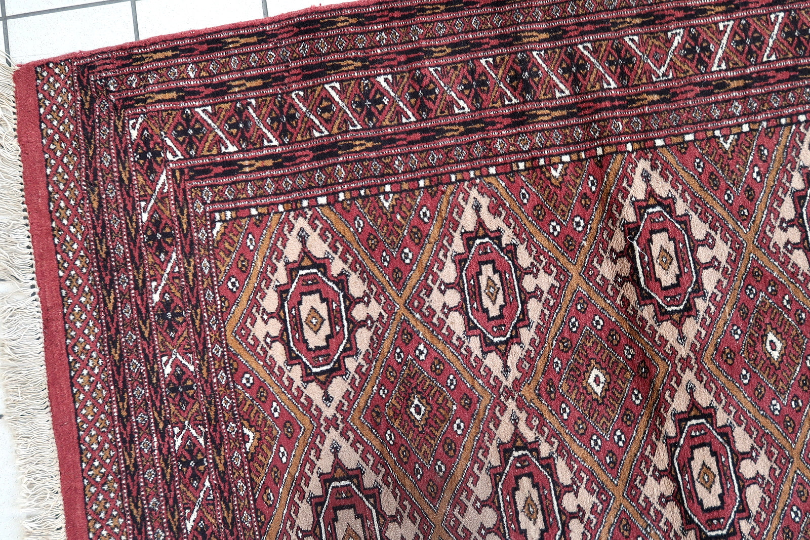 Handmade vintage Afghan Ersari rug in original good condition. The rug has been made in wool in the end of 20th century.