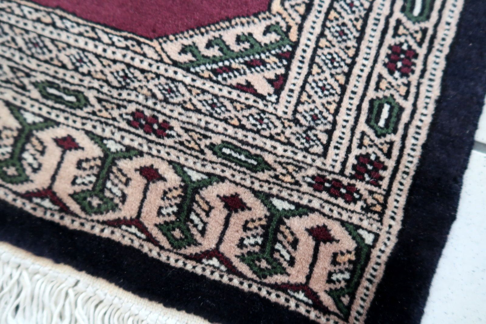 Handmade vintage Uzbek Bukhara mat in original good condition. The rug has been made in wool in the end of 20th century.