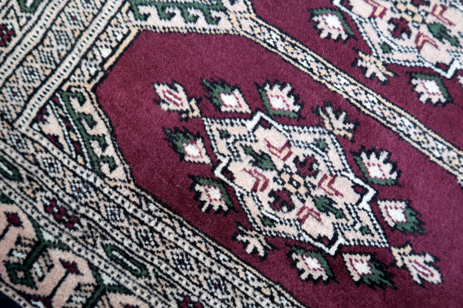 Handmade vintage Uzbek Bukhara mat in original good condition. The rug has been made in wool in the end of 20th century.