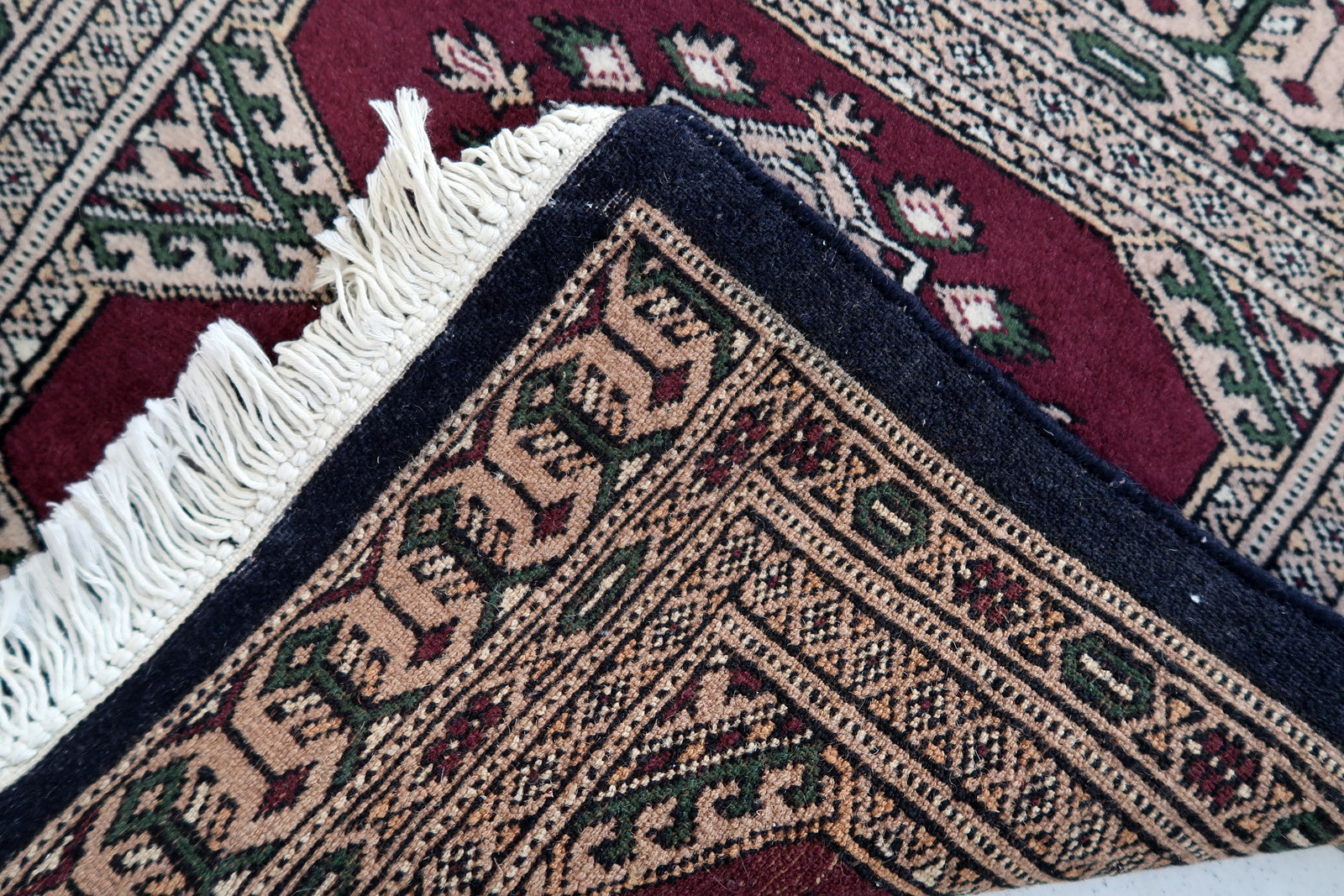 Handmade vintage Uzbek Bukhara mat in original good condition. The rug has been made in wool in the end of 20th century.
