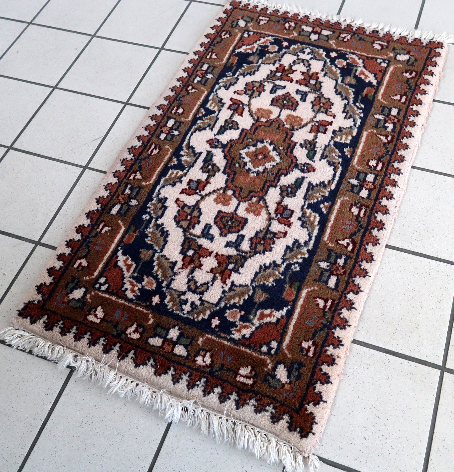 Handmade vintage Middle Eastern mat in light colors. The rug is from the end of 20th century in original good condition.