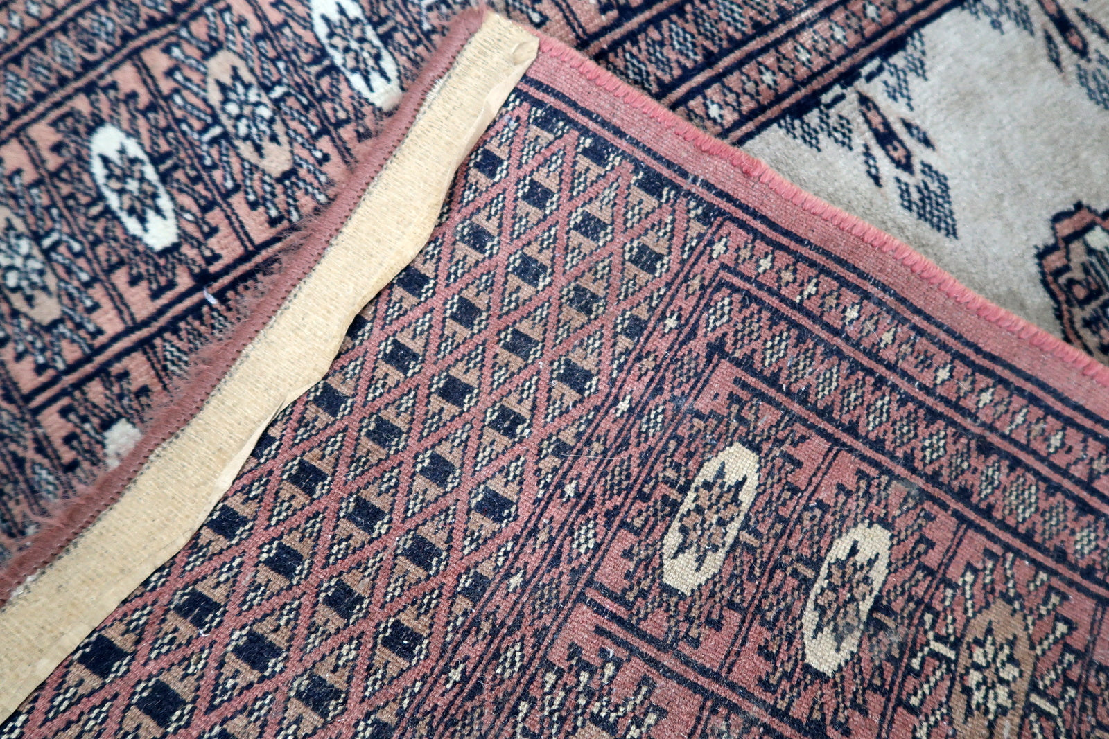 Handmade vintage Uzbek Bukhara distressed runner in traditional design. The rug is from the end of 20th century made in wool.
