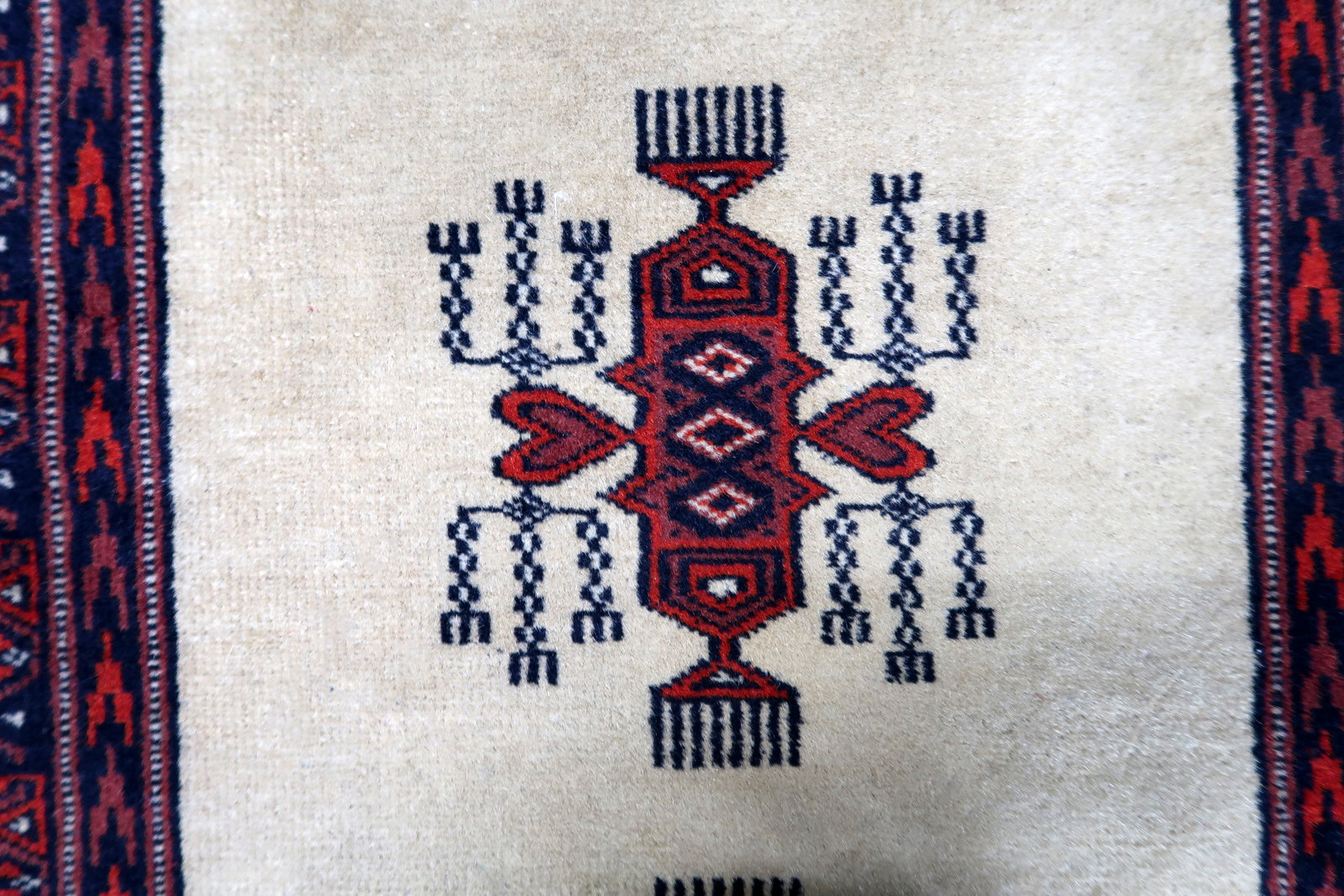 Handmade vintage Uzbek Bukhara runner in traditional design. The rug is from the end of 20th century made in wool.