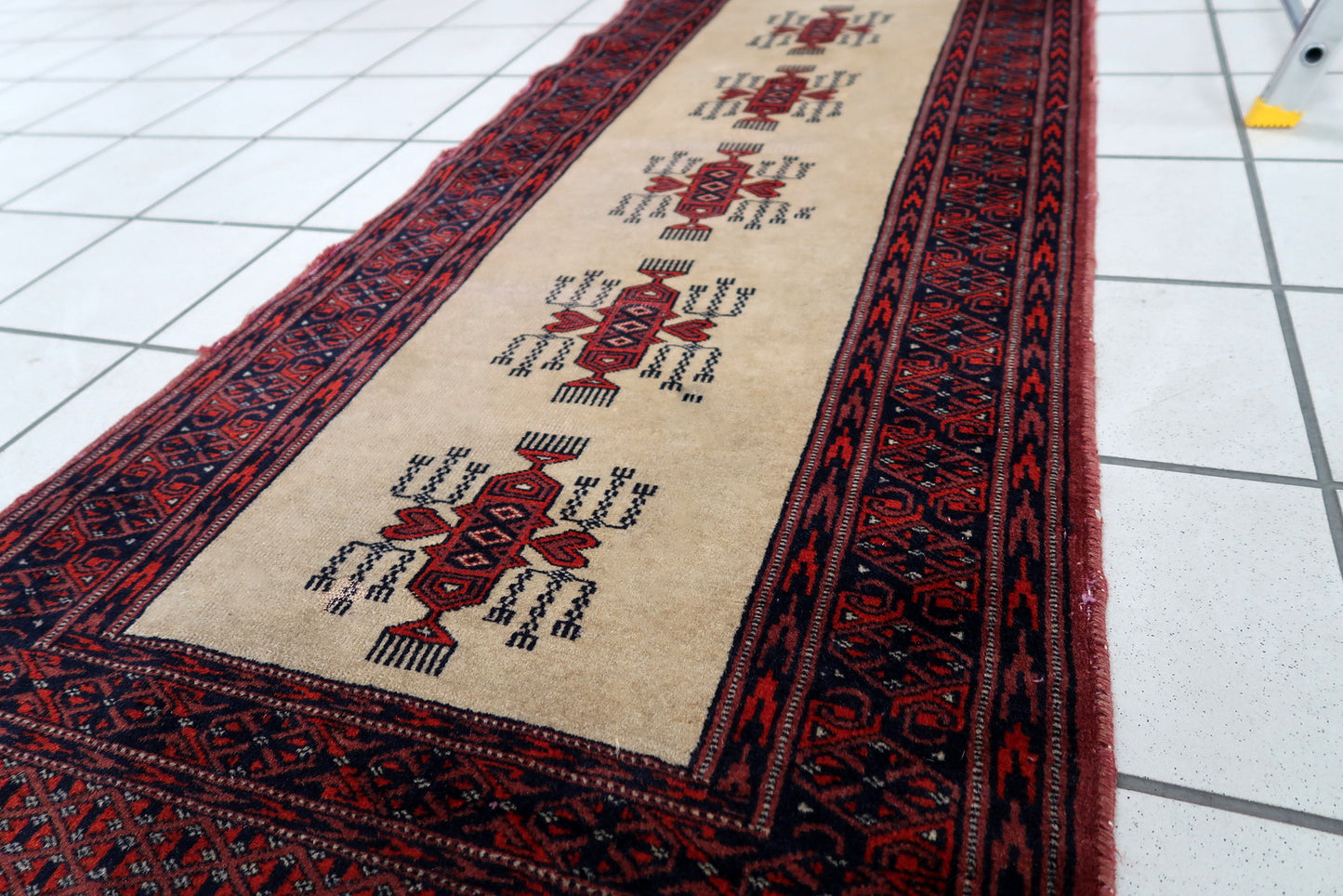 Handmade vintage Uzbek Bukhara runner in traditional design. The rug is from the end of 20th century made in wool.