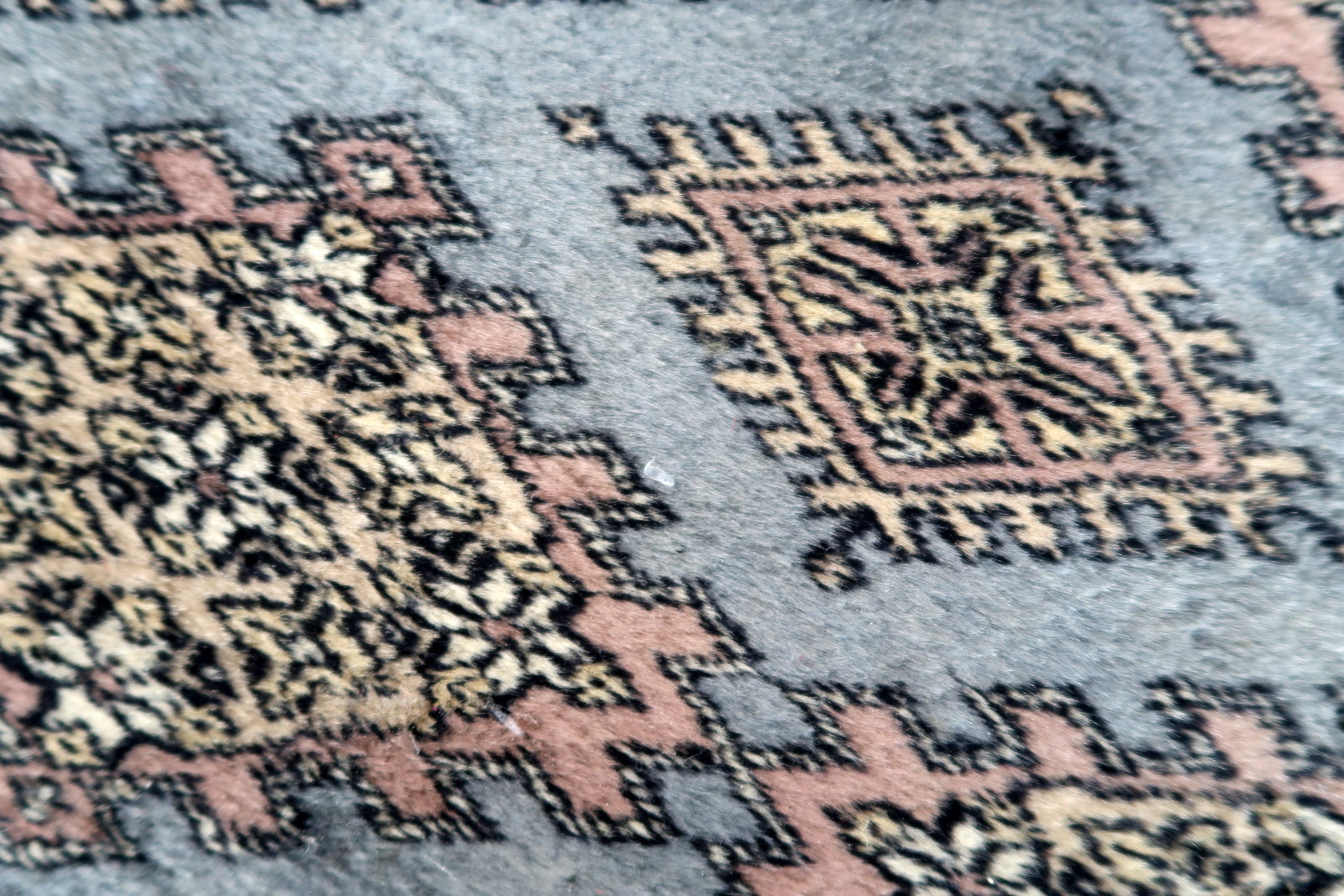 Handmade vintage Uzbek Bukhara runner in traditional design. The rug is from the end of 20th century made in wool.