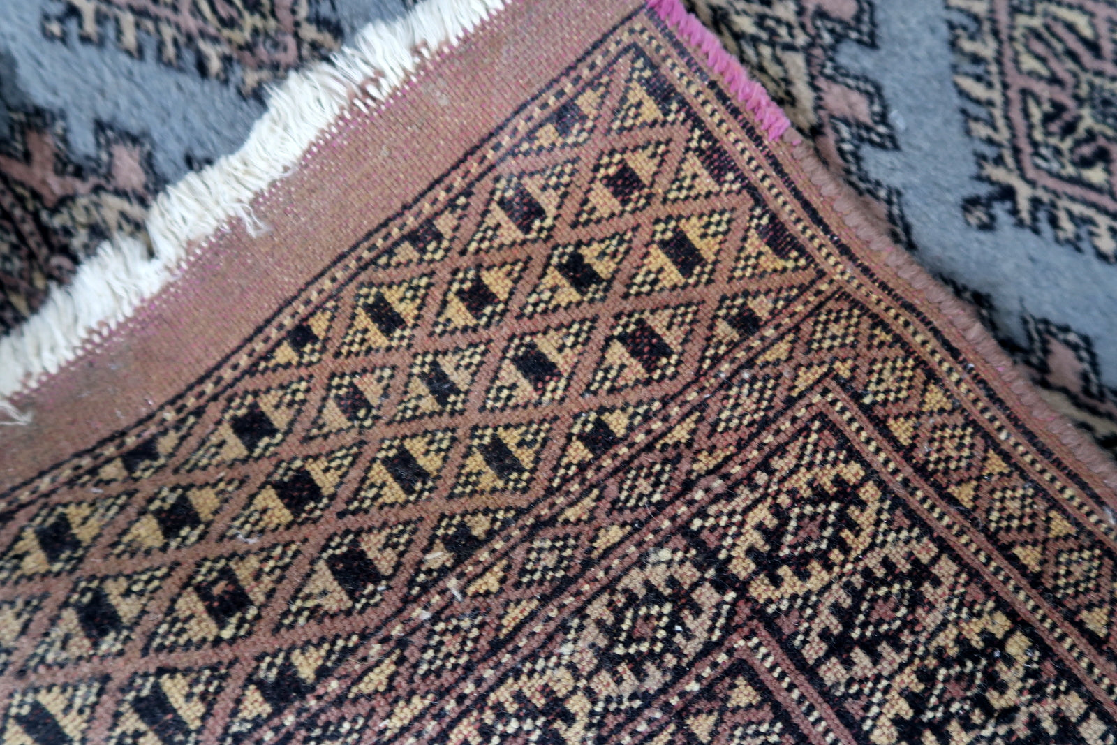Handmade vintage Uzbek Bukhara runner in traditional design. The rug is from the end of 20th century made in wool.