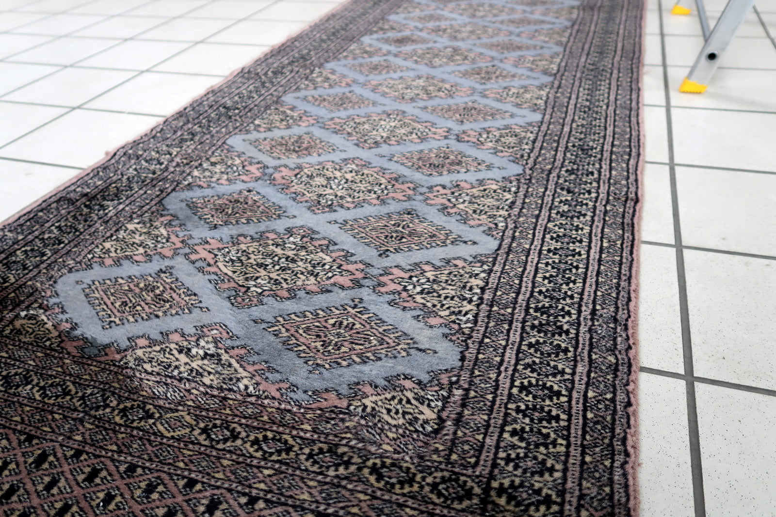 Handmade vintage Uzbek Bukhara runner in traditional design. The rug is from the end of 20th century made in wool.