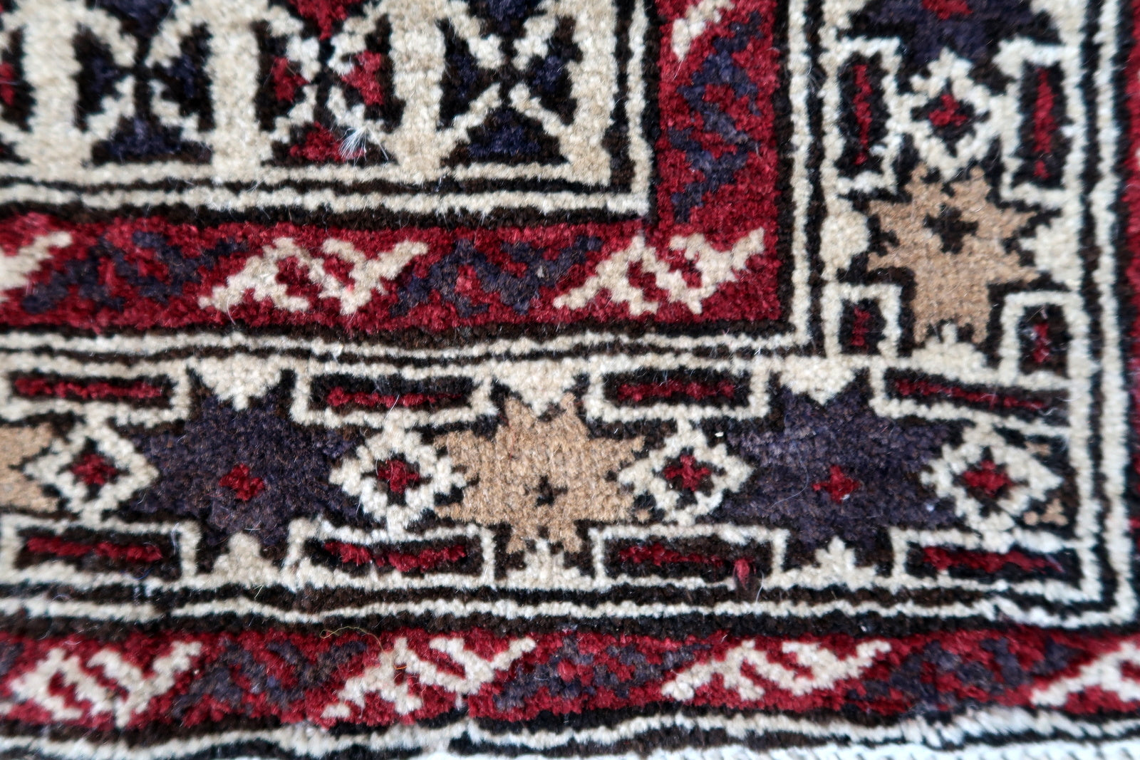 Handmade vintage Afghan Baluch rug in unusual multi-praying design. The rug is from the end of 20th century made in wool.